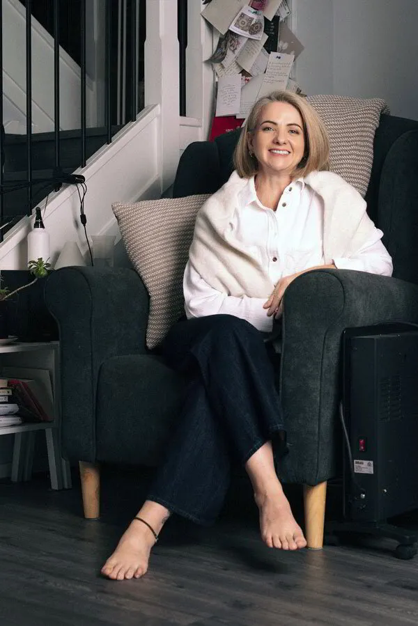 Jo sitting in an armchair and smiling